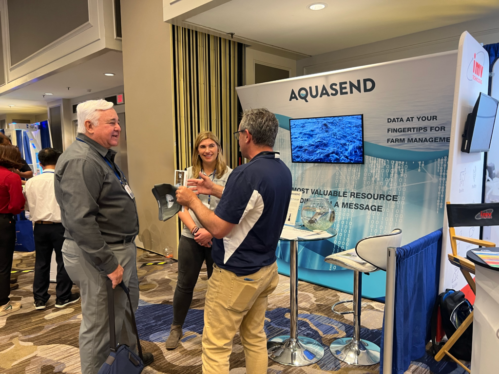 Kristin Elliott and two colleagues at a tradeshow